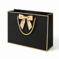 Borsa regalo 35 x 12 x 27 cm in cartoncino nero con fiocco dorato e manici a corda